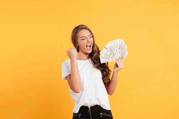 woman holding money and exclaiming
