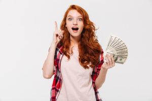 excited girl with money having an idea