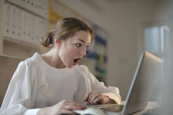 shocked woman on laptop